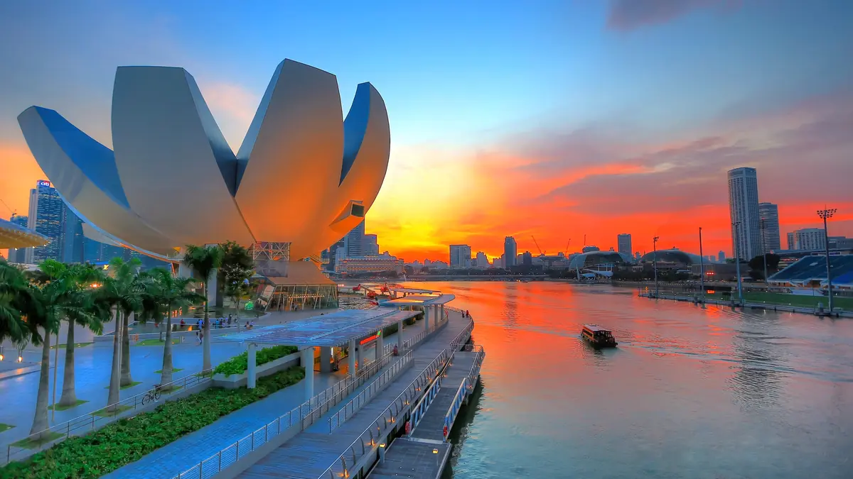 ArtScience Museum — The lotus-petal roof of the ArtScience Museum against a vivid orange sunset over Marina Bay