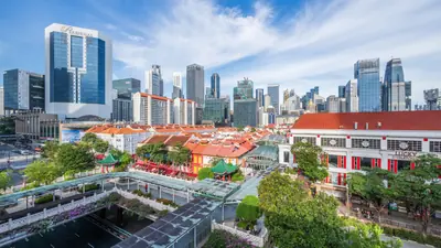 Chinatown's low shophouse rooftops with the Singapore CBD towers rising directly behind them