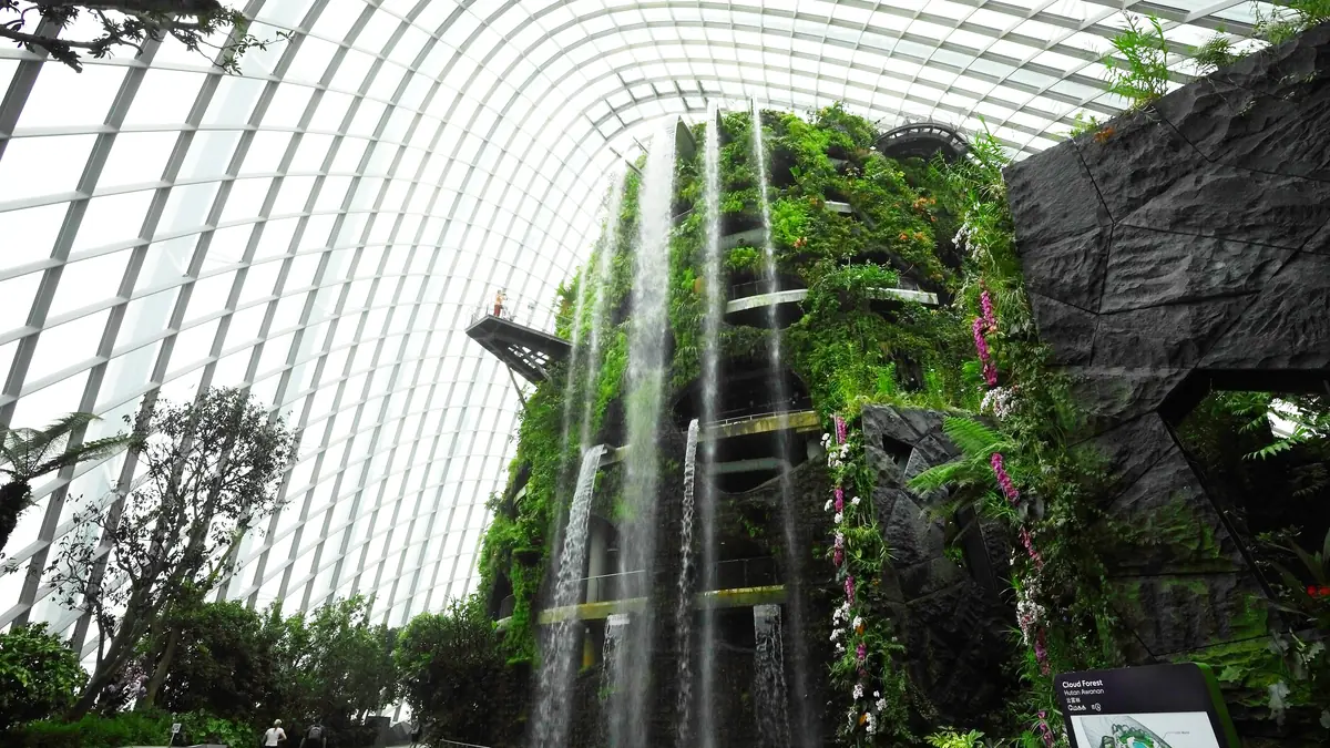 Gardens by the Bay — The indoor waterfall cascading down the planted rock face inside the Cloud Forest dome at Gardens by the Bay