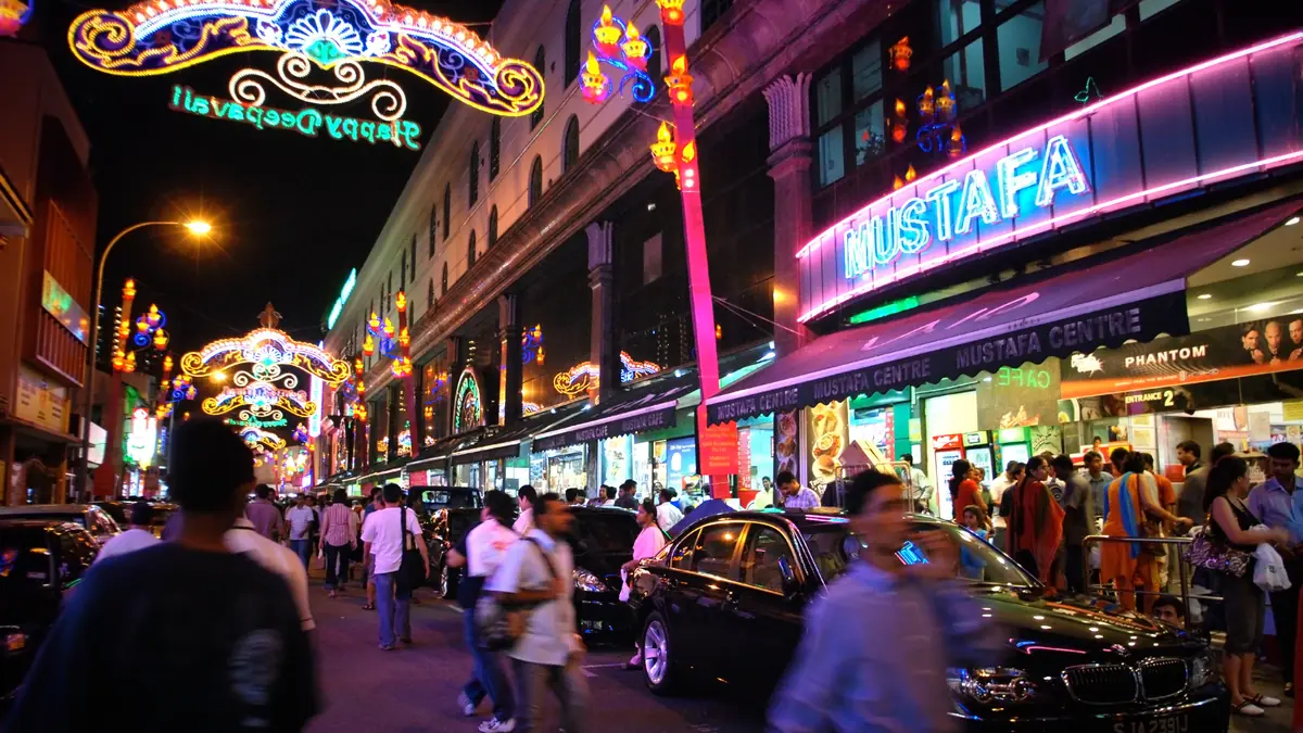 Little India — Crowds on the street outside Mustafa Centre in Little India at night under Deepavali light arches