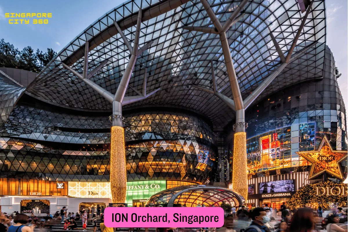 ION Orchard mall exterior on Orchard Road, its curved glass facade rising above the Orchard MRT station entrance